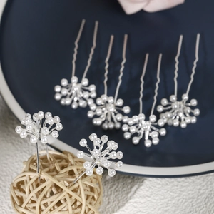 Detailed view of 6-piece bridal U-shaped hair pins with white faux pearl floral design
