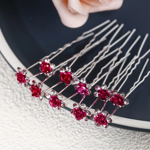 Close-up of rose red flower hair pins with sparkling rhinestones for bridal hairstyles