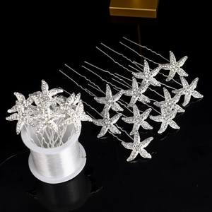 Macro detail of starfish hair pins with silver metal U-shaped pins and sparkling rhinestones