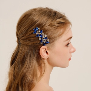 Detail of elegant bridal hair comb with deep blue marquise and clear round rhinestones