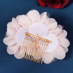 Détail macro de la structure arrière avec pétales de fleurs en maille rose et peigne doré
