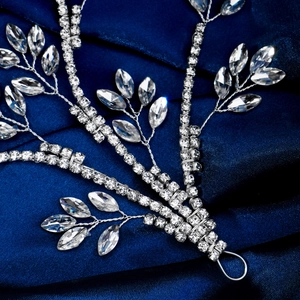 Detail of silver bridal hair vine with marquise rhinestones on blue silk fabric
