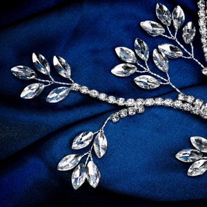 Macro shot of silver bridal hair vine with marquise rhinestones on blue satin