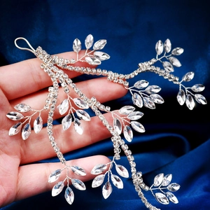 Close-up of handmade bridal headband with silver wire branches and crystal rhinestones
