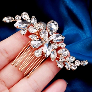 Detailed macro view of a gold rhinestone hair comb for brides with floral crystal patterns