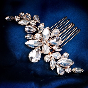 Elegant bridal hair comb with sparkling rhinestones and golden leaf design on navy silk