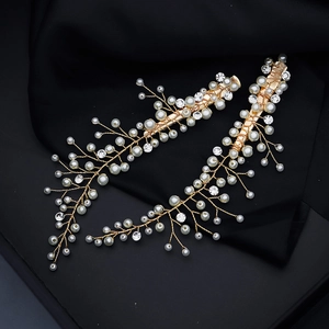 Gros plan de barrettes dorées avec perles blanches et cristaux pour mariage élégant