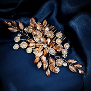 Macro shot of gold wire hair comb with amber marquise crystals and rhinestones