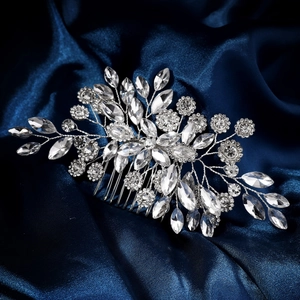 Macro shot of wedding hair comb with silver marquise rhinestones on blue satin background