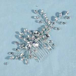 Detailed view of silver bridal hair comb with intricate crystal leaves and rhinestones