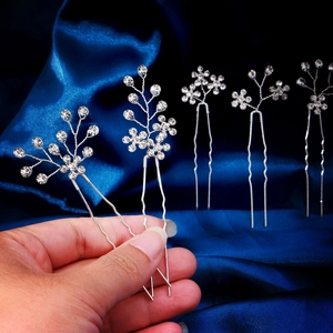 Macro detail of U-shaped hair pins with silver twisted wire and sparkling rhinestones