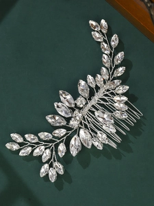 Close-up of leaf-shaped silver bridal hair comb with shimmering marquise crystals