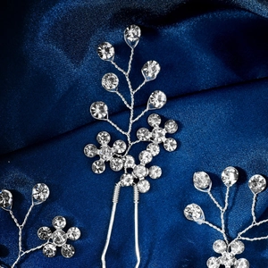 Macro detail of handmade bridal hair pin with silver wire and sparkling rhinestones