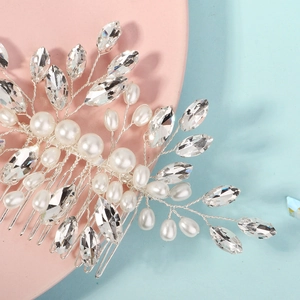 Macro shot of silver bridal hair comb with pearls and marquise rhinestones