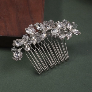 Detail of silver bridal hair comb with shimmering crystals and elegant floral patterns