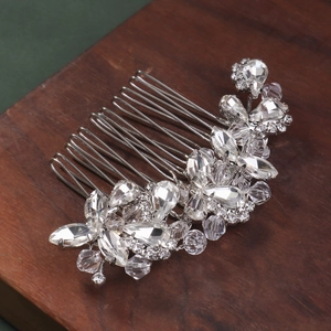 Macro shot of silver bridal hair comb with faceted crystals in floral leaf pattern