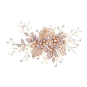 Detail of bridal hair clip with champagne tulle flowers, pearls and crystal beads