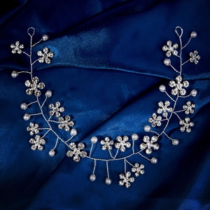 Elegant bridal hair vine with silver rhinestones and white pearls on navy satin