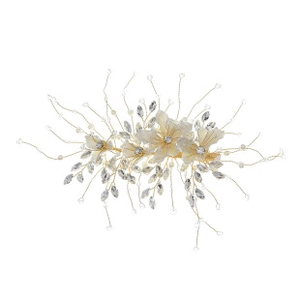 Close-up of handmade bridal hair clip with white fabric flowers and beaded wire design