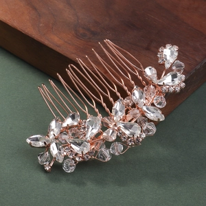 Macro shot of rose gold floral bridal hair comb with sparkling rhinestones details