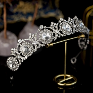 Silver vintage sunflower crystal crown for brides on a elegant black metal display stand