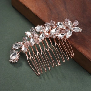 Detailed macro of rose gold bridal hair comb with marquise and pear-cut rhinestones