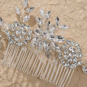 Macro shot of silver bridal hair comb with crystal floral petals and leaf patterns