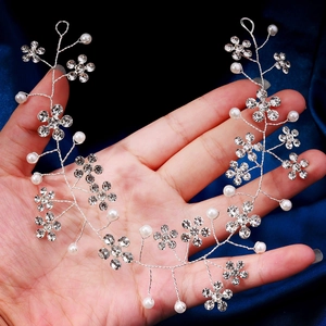 Detailed macro view of handmade silver floral hair vine with rhinestones and faux pearls
