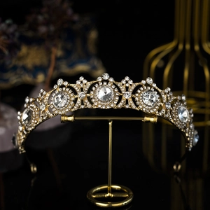 Macro detail of golden wedding crown with sparkling rhinestones on elegant black background