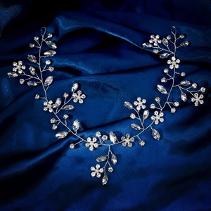 Detailed close-up of bridal headband with silver wires, rhinestones and pearls
