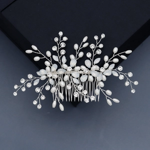 Detailed view of handmade silver floral hair comb with pearls and blue leaf accents