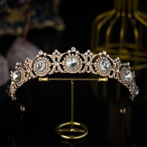 Luxurious gold sunflower bridal crown with sparkling white rhinestones on black background
