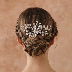 Close-up of a sparkling bridal hair comb with crystals and pearls on elegant updo