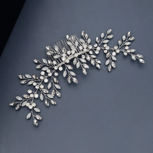 Detail of silver bridal hair comb with marquise crystals and opal stones on dark background