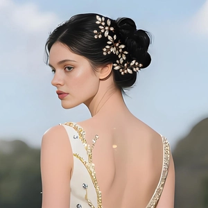 Detailed shot of handmade gold wire bridal headpiece with crystal leaves and flowers