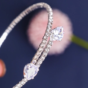 Macro shot of sparkling silver-tone bypass cuff featuring two large pear-cut cubic zirconia