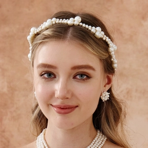 Detail of handcrafted woven imitation pearl headband and matching bridal jewelry set