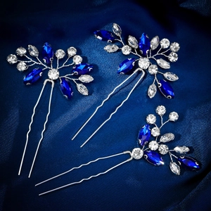 Set of three silver U-shaped hair pins with navy blue rhinestones on blue silk fabric