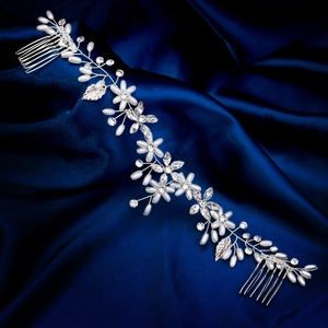 Handmade bridal hair vine with white pearls and crystal floral accents on blue satin