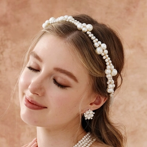 Detail of hand-woven pearl headband and flower earrings for bridal wedding hair accessories