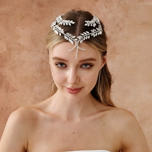 Detail of silver leaf bridal headpiece featuring shimmering rhinestones and fringes
