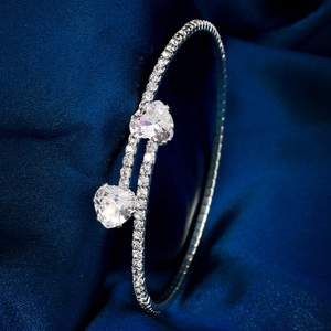 Detailed macro view of silver open cuff bracelet with sparkling heart-cut cubic zirconia stones