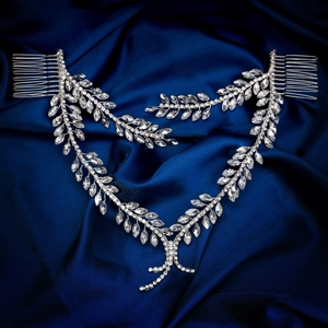 Elegant bridal hair vine with silver leaf design and shimmering crystals on blue silk