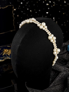Detail view of hand-woven faux pearl headband with golden wire for bridal hair styling