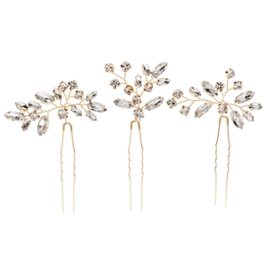 Three-piece gold bridal hair pin set with sparkling marquise crystal leaves and floral design