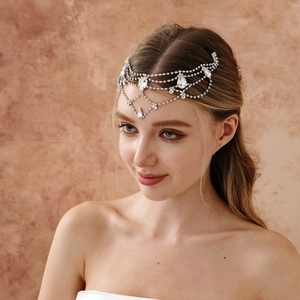 Detail of bohemian bridal headpiece featuring silver tassels and teardrop rhinestones