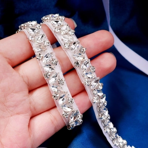Macro shot of bridal crystal belt featuring marquise rhinestones on white mesh ribbon