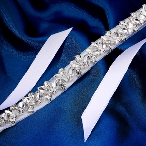 Elegant thin bridal belt with sparkling crystal rhinestones on white ribbon for wedding gowns