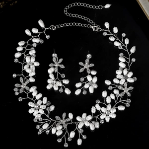 Detailed view of handmade pearl bridal jewelry set with floral necklace and earrings