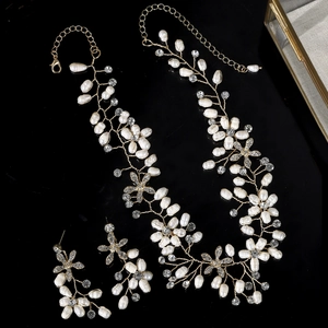 Detail of bridal jewelry set with pearls and crystals on a black reflective surface